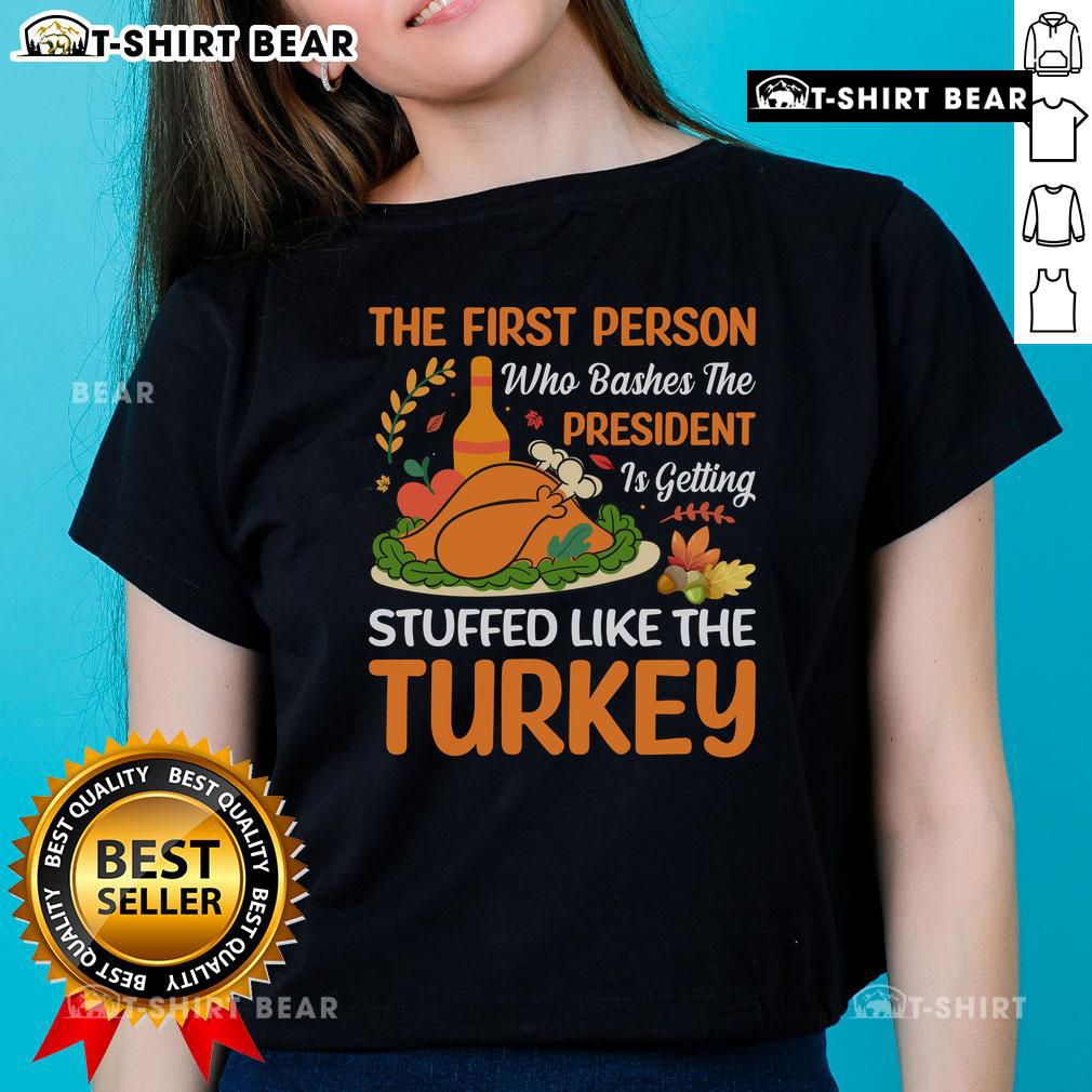 Funny 'Top-The-First-Person-Who-Bashes-The-President' turkey-themed ladies tee, perfect for holiday humor.
