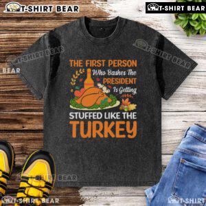 Graphic t-shirt featuring a humorous design about bashing the president, featuring a turkey and playful text.