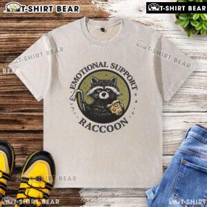 Adorable raccoon wearing a washed t-shirt, showcasing its role as a good emotional support animal in a cozy setting.