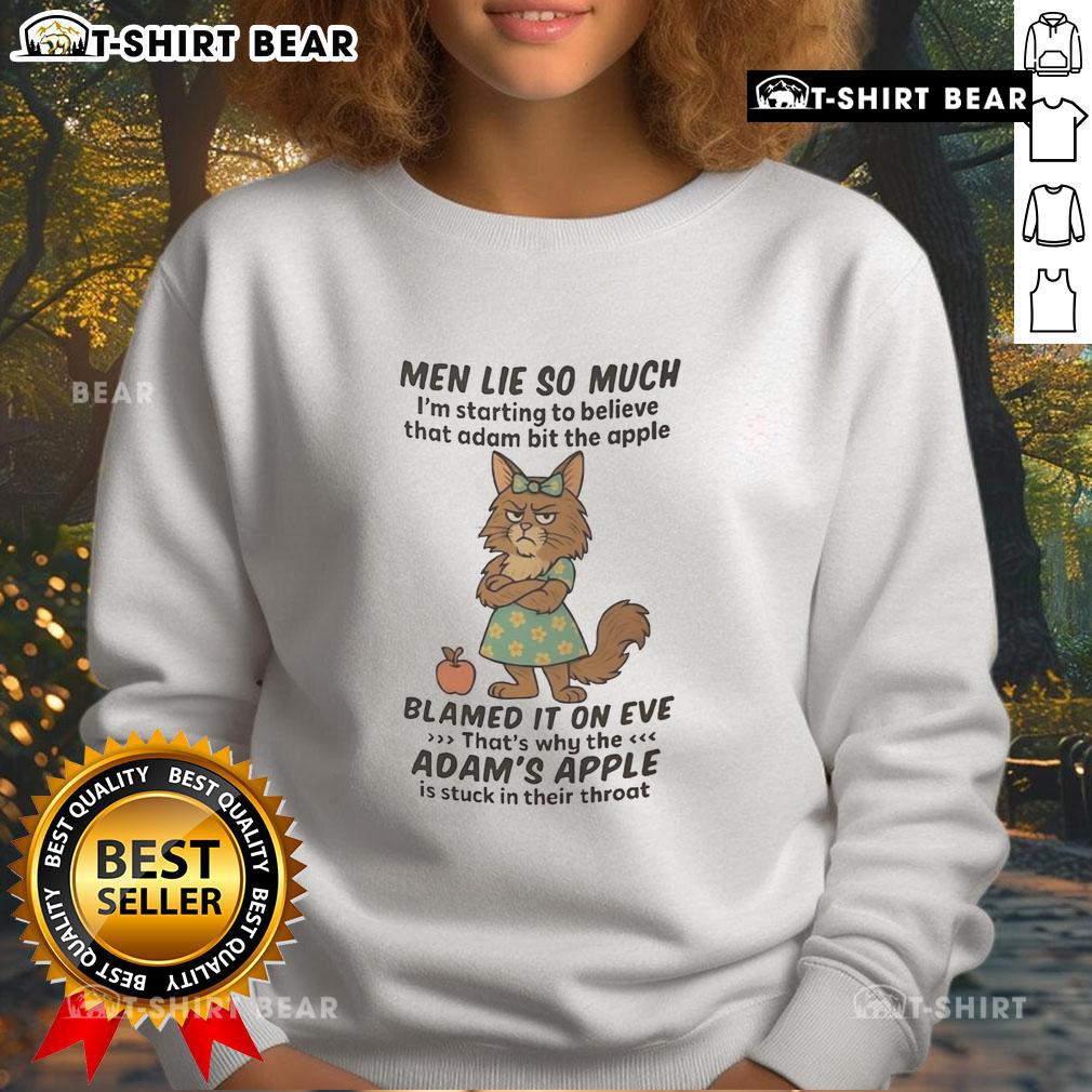 Man wearing a 'Good Maine Coon' sweatshirt, humorously referencing Adam and the apple, with a playful cat nearby.
