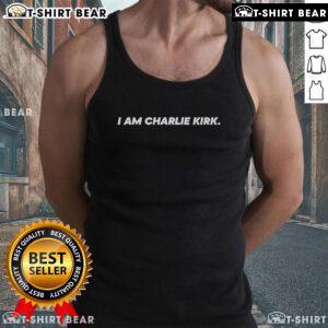 Charlie Kirk wearing a 'I Am Charlie Kirk' tank top on The Charlie Kirk Show, promoting conservative values.
