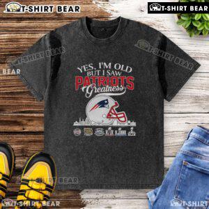 Vintage New England Patriots Super Bowl helmet graphic on a washed t-shirt, celebrating football greatness.