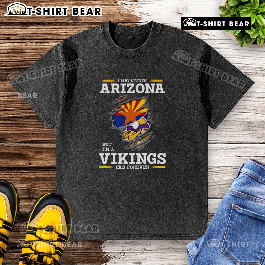 Original I May Live In Arizona But I'm A Minnesota Vikings Fan Forever washed t-shirt displayed on a hanger.