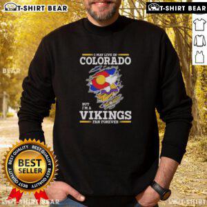 Alt Text: Cozy sweatshirt featuring I May Live In Colorado But I'm A Minnesota Vikings Fan Forever design, perfect for fans.