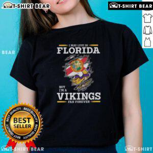 Original I May Live In Florida But I'm A Minnesota Vikings Fan Forever ladies tee in vibrant purple and gold design.
