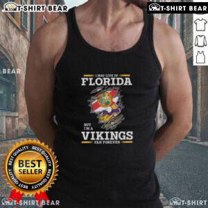 Tank top with 'I May Live In Florida But I'm A Minnesota Vikings Fan Forever' design, perfect for NFL fans.