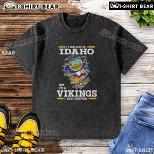Original I May Live in Idaho But I'm a Minnesota Vikings Fan Forever washed t-shirt displayed on a rustic background.
