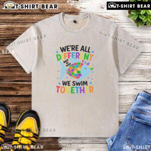 Alt Text: Colorful fish design on washed t-shirt with the phrase 'We're All Different, But In This Class, We Swim Together'.