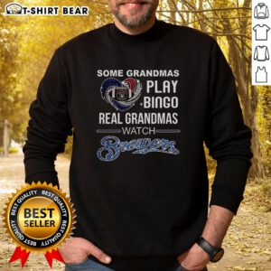 Grandmas enjoying Bingo in Milwaukee, wearing 'Real Grandmas Watch Brewers Baseball' sweatshirts, celebrating fun times.