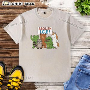 Protest t-shirt featuring a frog, unicorn, raccoon, bear, and dinosaur with 'Good Abolish ICE' slogan in vibrant colors.