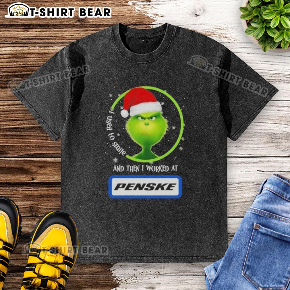 Good Grinch Christmas T-shirt featuring a whimsical design with text about smiling and working at Penske Corporation.