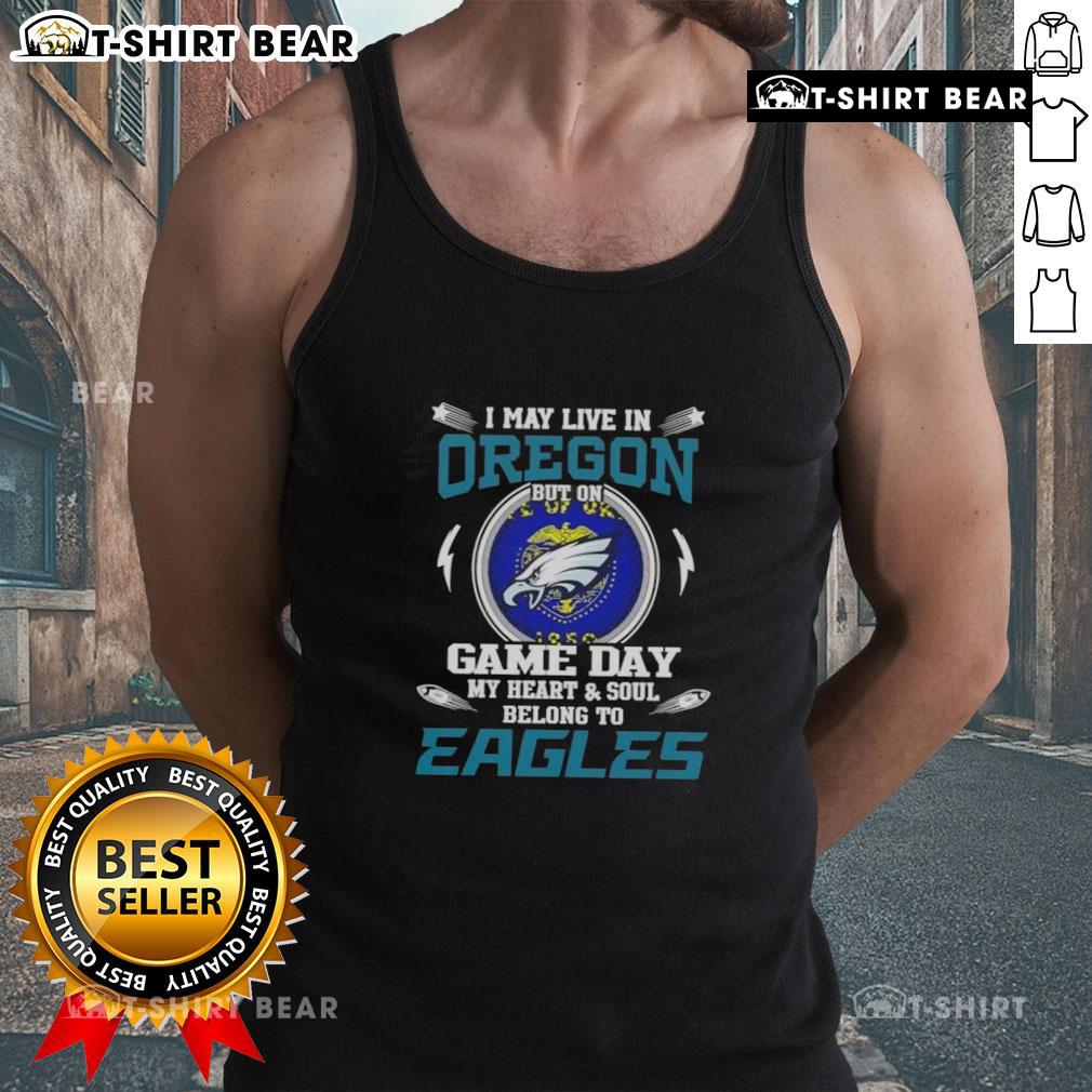 Woman wearing a Philadelphia Eagles tank top, proudly showing team spirit, with an Oregon backdrop.