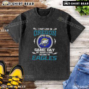 Alt Text: Washed t-shirt featuring 'I May Live In Oregon But My Heart Belongs To Philadelphia Eagles' design for fans.