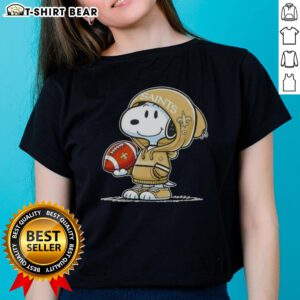 Snoopy in a hoodie, smiling at fans, showcasing the New Orleans Saints on a ladies tee - Official Peanuts design.