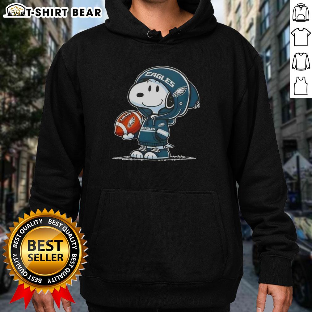 Alt Text: Snoopy in a Philadelphia Eagles hoodie smiling at fans, showcasing official Peanuts merchandise.