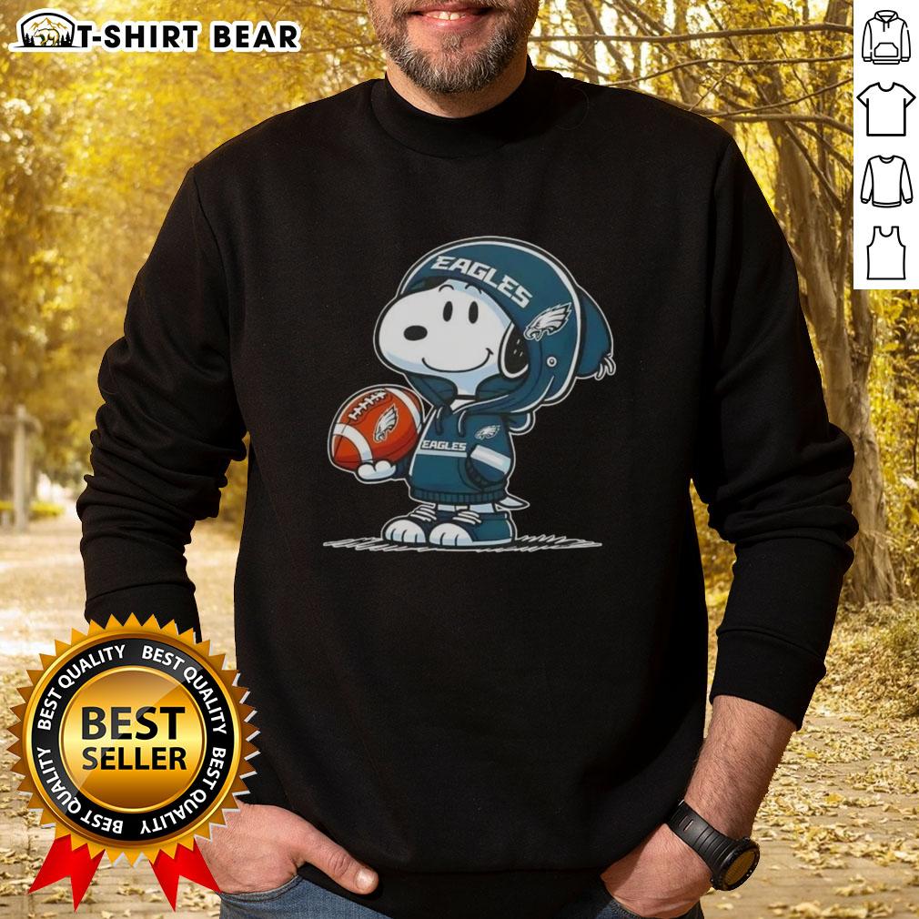 Alt Text: Snoopy in a hoodie smiling at fans, wearing Philadelphia Eagles sweatshirt, perfect for Peanuts fans and sports lovers.