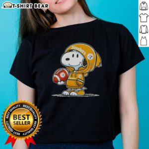 Snoopy wearing a Pittsburgh Steelers hoodie smiles at fans on a ladies tee, showcasing official Peanuts merchandise.