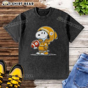 Alt Text: Snoopy in a hoodie smiles at fans, showcasing an Official Peanuts Pittsburgh Steelers washed t-shirt design.