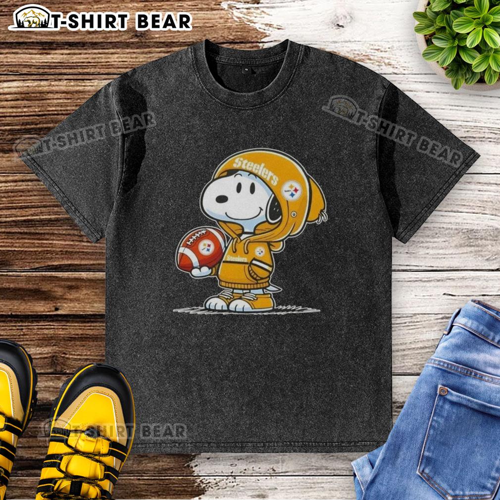 Alt Text: Snoopy in a hoodie smiles at fans, showcasing an Official Peanuts Pittsburgh Steelers washed t-shirt design.