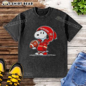 Snoopy wearing a San Francisco 49ers hoodie, smiling at fans on a washed t-shirt design, perfect for Peanuts fans.