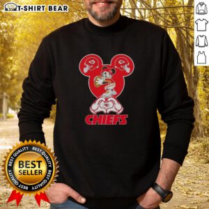Alt Text: Top Mickey hands heart design on Kansas City Chiefs football sweatshirt, perfect for fans and cozy game days.