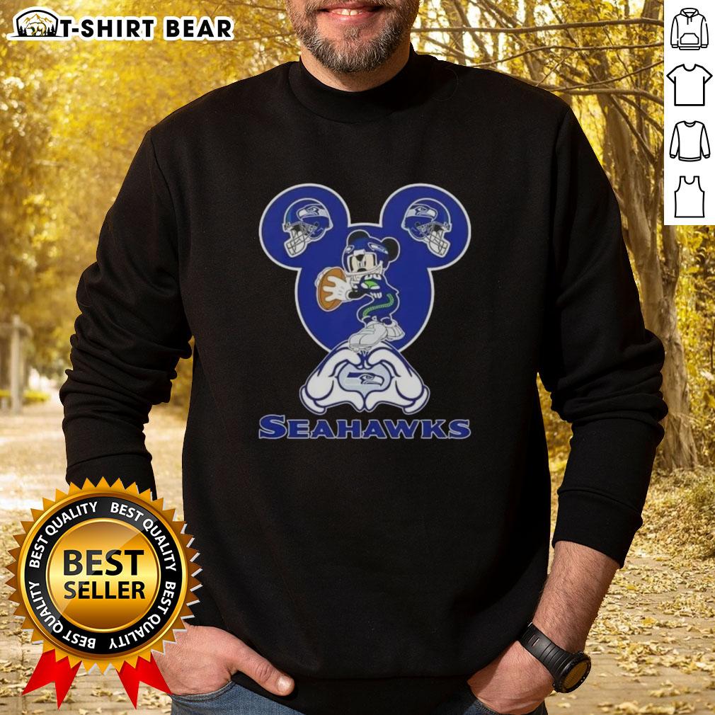 Seattle Seahawks sweatshirt featuring top Mickey hands forming a heart, perfect for fans showing love for football.