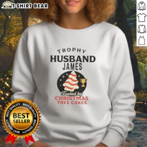 Alt Text: Awesome Trophy Husband James wearing a Christmas Tree Cakes sweatshirt, showcasing festive holiday spirit and style.