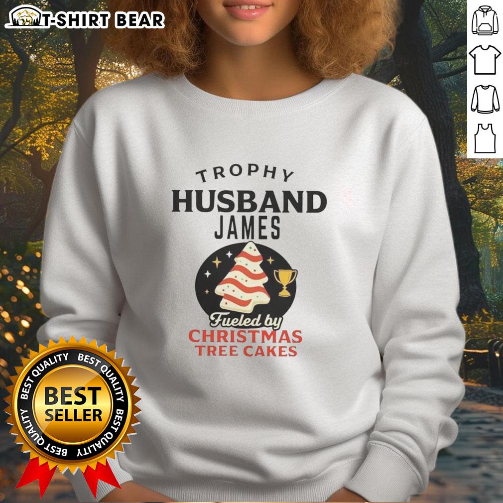 Alt Text: Awesome Trophy Husband James wearing a Christmas Tree Cakes sweatshirt, showcasing festive holiday spirit and style.