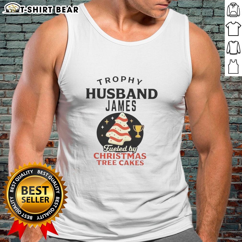 Awesome Trophy Husband James wearing a festive tank top, enjoying Christmas Tree Cakes, ready for holiday fun.