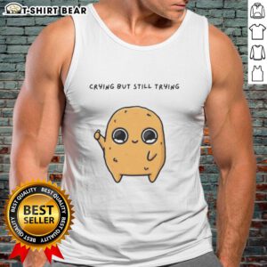 Alt Text: Cartoon mascot wearing a tank top, showing a good-sad nuggie expression while crying but trying to smile.
