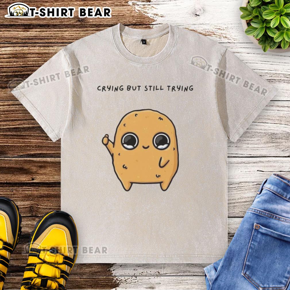 Alt Text: Good Sad Nuggie crying but trying mascot cartoon on a washed t-shirt, perfect for casual wear and expressing emotions.
