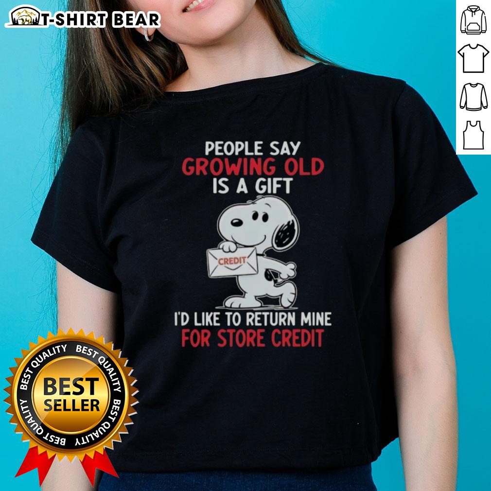 Funny ladies' tee featuring Snoopy with the quote about growing old as a gift, perfect for humor and nostalgia lovers.