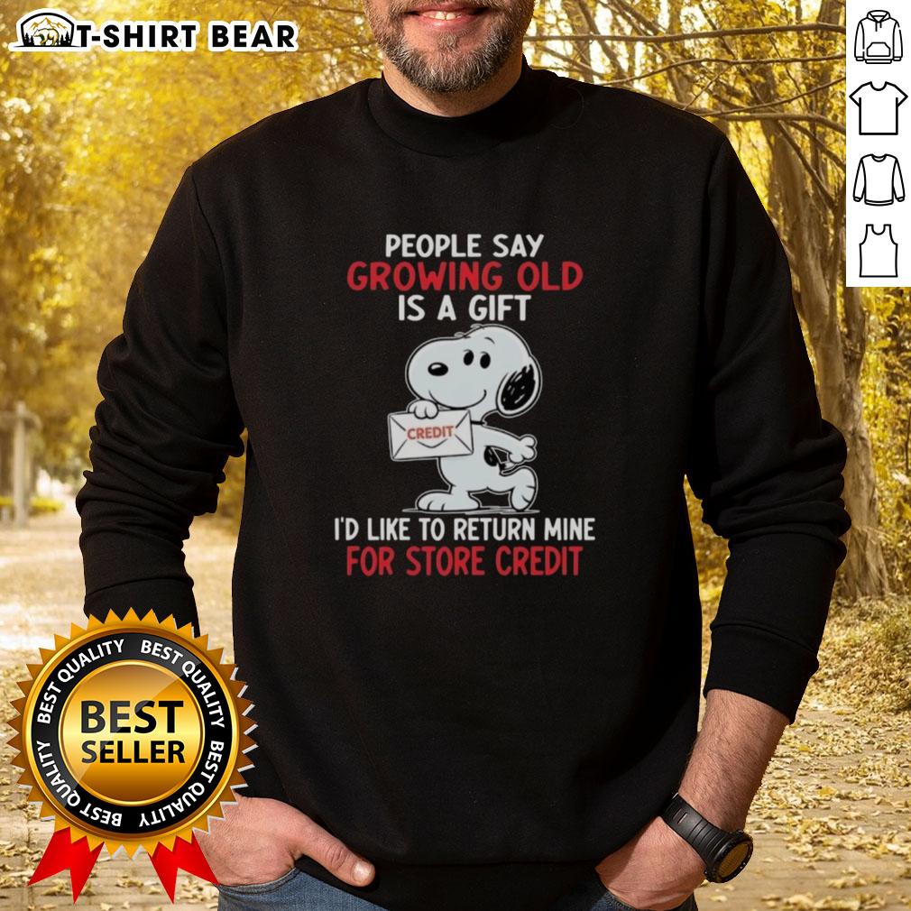 Funny sweatshirt featuring Snoopy with 'Growing old is a gift, I'd like to return mine for store credit' quote.