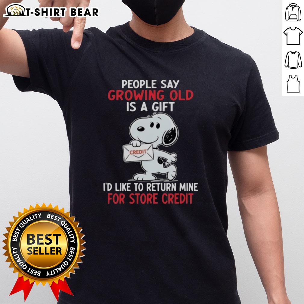 Funny Snoopy t-shirt with 'Growing Old Is A Gift, I'd Like To Return Mine for Store Credit' design, perfect for humor lovers.