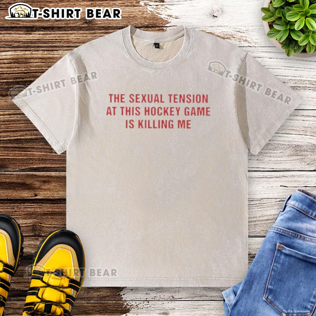 Good The Sexual Tension In This Hockey Game Is Killing Me Text Washed T-Shirt displayed on a wooden background.