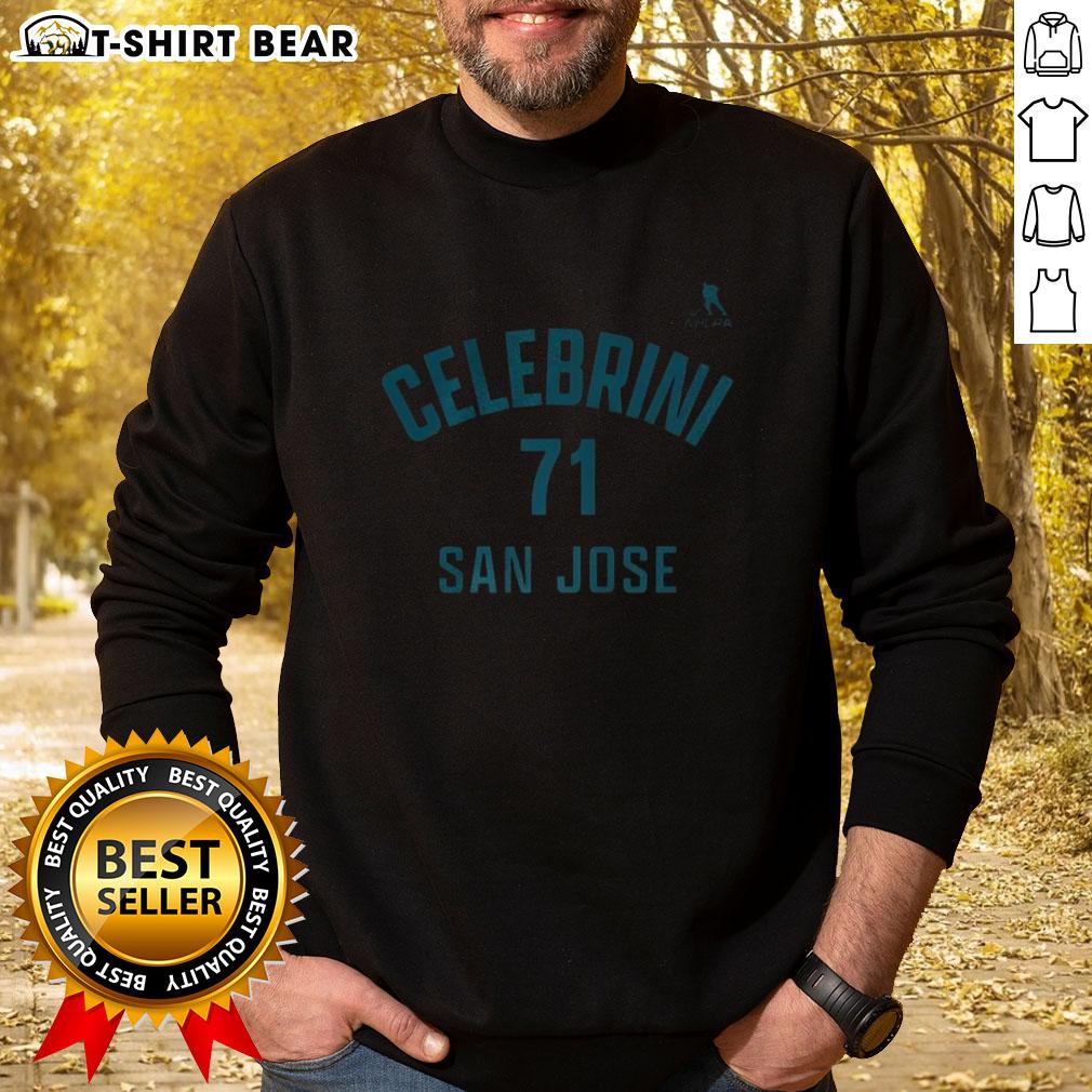 Alt Text: Happy Macklin Celebrini wearing a San Jose Sharks sweatshirt with name and number 71, showcasing team spirit.