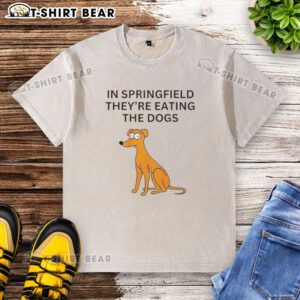 People wearing 'Nice in Springfield They're Eating the Dogs' washed t-shirt, enjoying a sunny day outdoors.