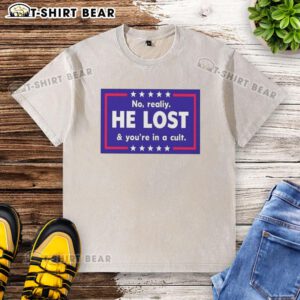 Nice No Reality He Lost and You're in a Cult washed t-shirt displayed on a hanger in a stylish room.