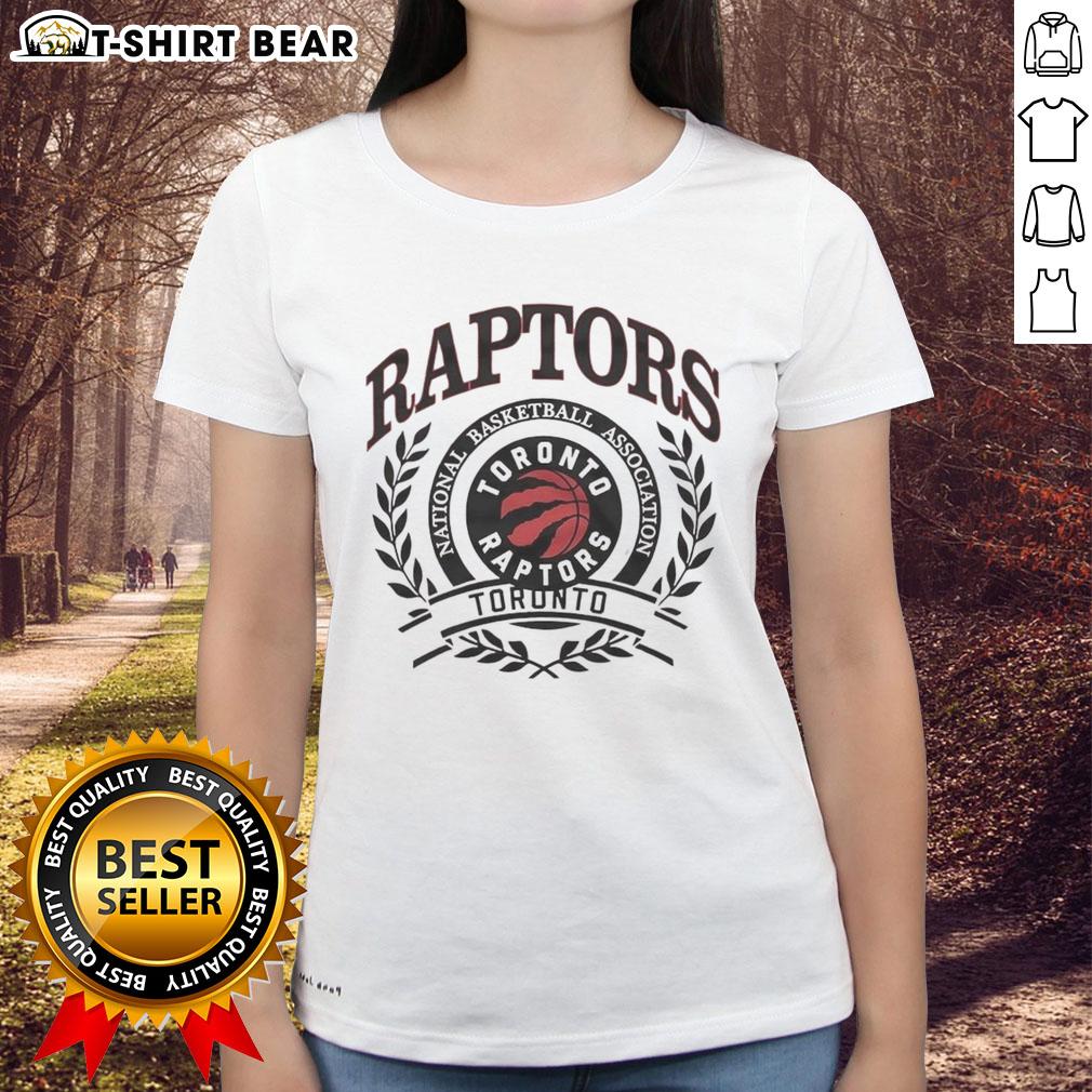Vintage Toronto Raptors logo in a laurel wreath frame on a ladies' tee, perfect for NBA fans and retro apparel lovers.