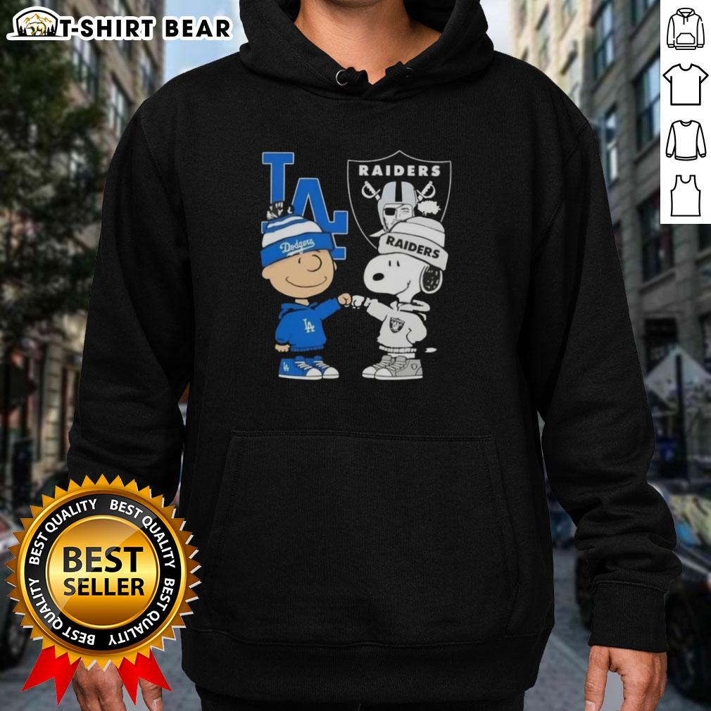 Alt Text: Original Charlie Brown fist bump with Snoopy in Los Angeles sports hoodie featuring Dodgers and Raiders logos.