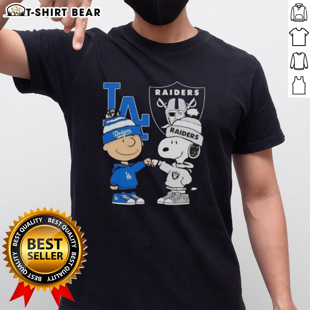 Alt Text: Original Charlie Brown fist bump with Snoopy on a Dodgers X Raiders T-Shirt, perfect for LA sports fans.