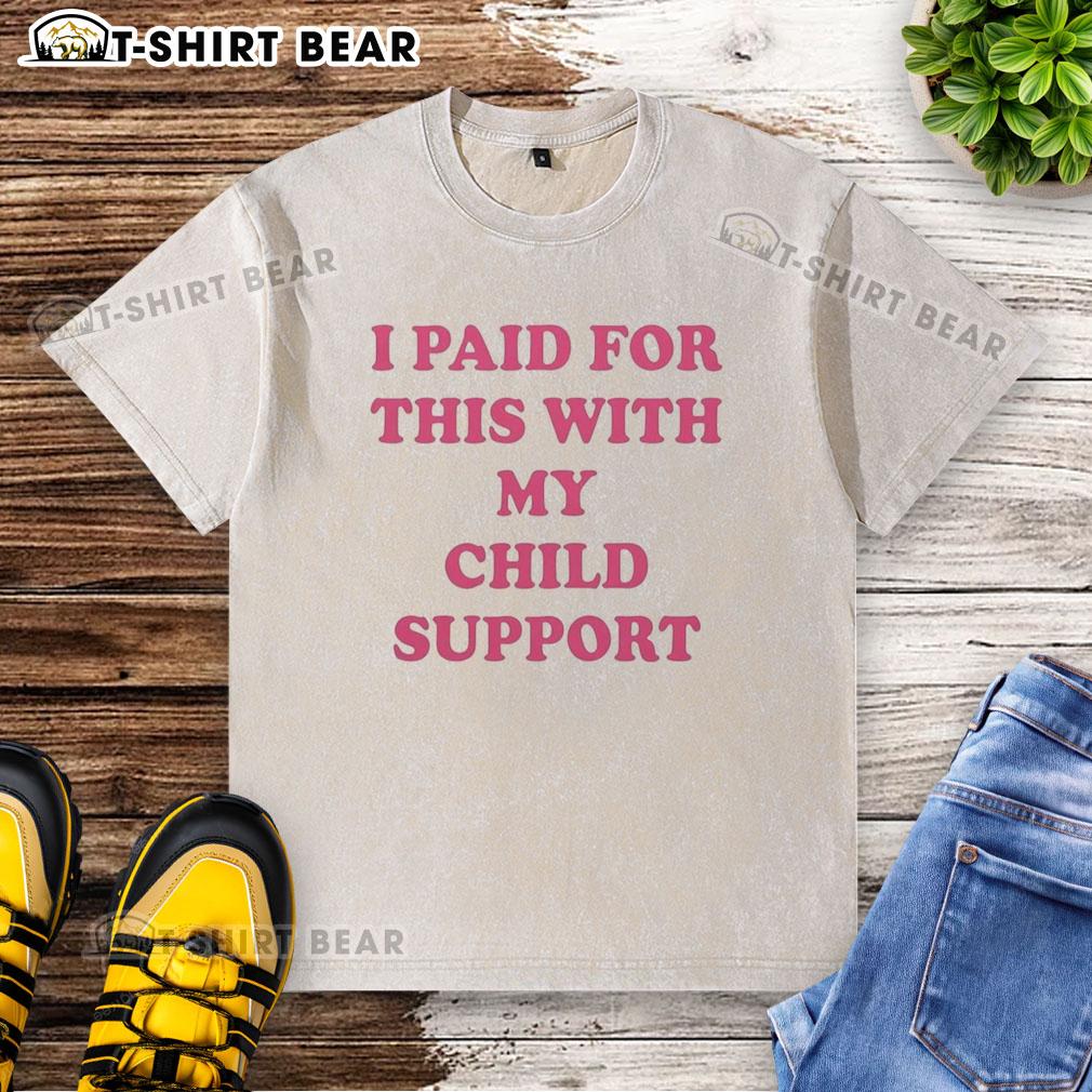 Original 'I Paid For This With My Child Support' washed t-shirt displayed on a hanger, showcasing its playful design.