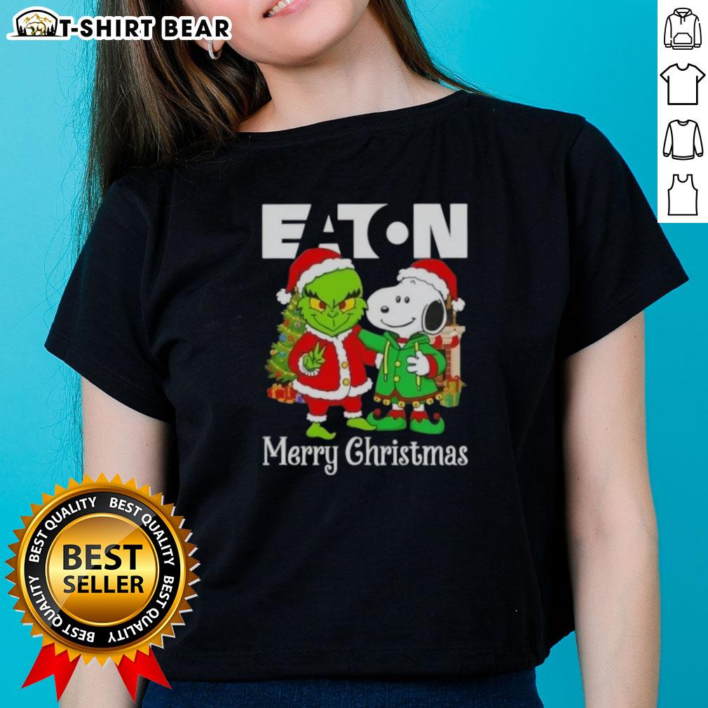 Alt Text: Ladies' tee featuring Eaton Corporation X Grinch and Snoopy designs for a merry Christmas celebration.