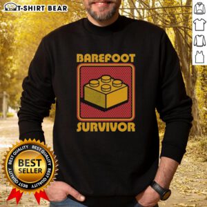 Top Foot Brick Survivor sweatshirt featuring a playful 'Barefoot Lego Survivor' design for Lego enthusiasts and fans.