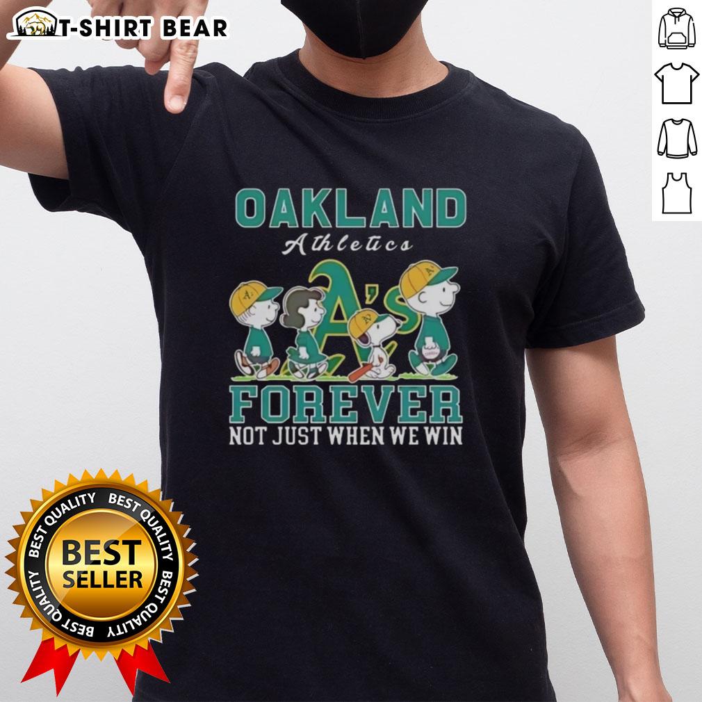 Alt Text: Cute Snoopy and Charlie Brown Oakland Athletics baseball t-shirt showcasing 'Forever Not Just When We Win' slogan.