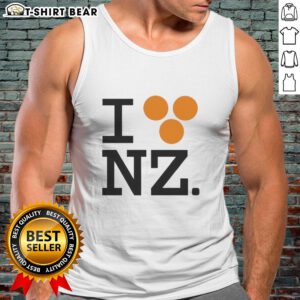 Orlando Bloom wearing a 'Good I Love NZ' tank top, showcasing a stylish and casual look perfect for summer vibes.