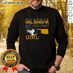 Girl wearing 'Good You Can Take This Girl Out Of Oklahoma' sweatshirt, showcasing Oklahoma pride and style.