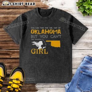 Girl wearing a 'Good You Can Take This Girl Out Of Oklahoma' washed t-shirt, showcasing Oklahoma pride and style.