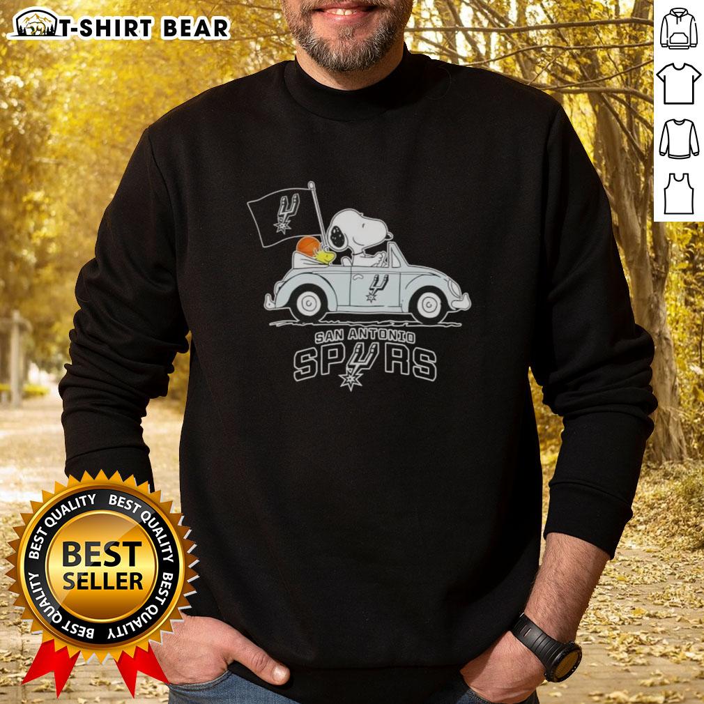 Alt Text: Snoopy driving a car in a San Antonio Spurs basketball sweatshirt, showcasing a fun sports-themed design.