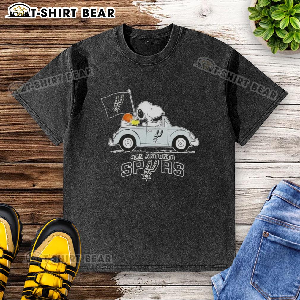 Snoopy driving a car in a San Antonio Spurs basketball themed washed t-shirt, showcasing fun sports apparel.